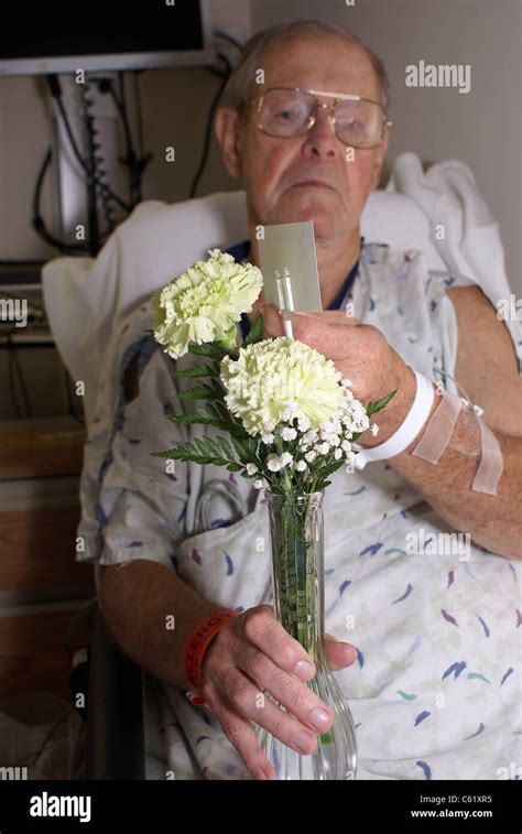 Hospital patient holding gift flowers Stock Photo - Alamy