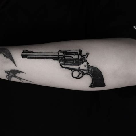 Black and white revolver tattoo done at BK Ink Studio - Tattoogrid.net