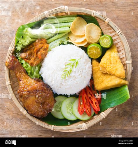 Famous traditional Indonesian food. Delicious nasi ayam penyet with ...