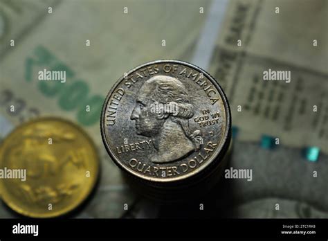 US Quarter dollar is stacked under Indian currency of five hundred rupees along with coins Stock ...