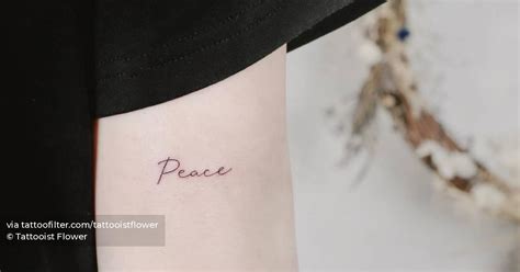 Lettering tattoo of the word "peace" located on the