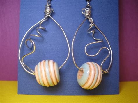 Wire Earrings With A Yellow Blue Bead · How To Make A Pair Of Wire Earrings · Jewelry Making on ...