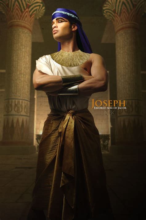 an egyptian man with his arms crossed in front of some columns and wearing a blue turban