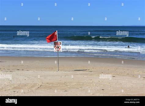 Red flag on beach Stock Photo - Alamy