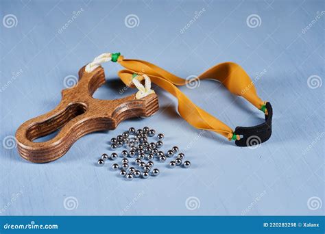 Professional Slingshot and Ammo on Blue Stock Photo - Image of closeup ...