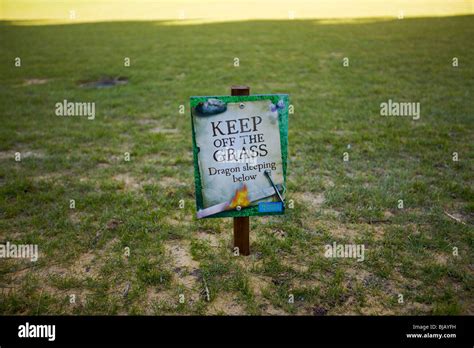 A funny keep off the grass sign at warwick castle in the UK Stock Photo ...