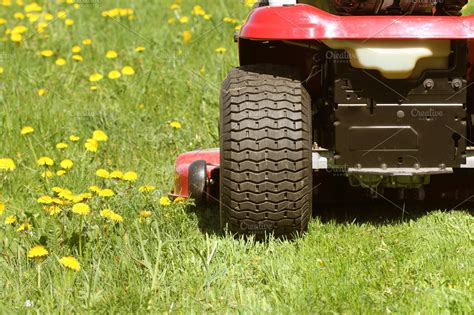 cutting the grass of on a tractor la ~ Industrial Photos ~ Creative Market