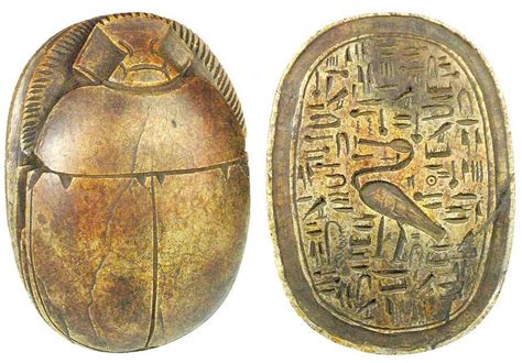 Ancient Egyptian scarabs. Carved brown limestone heart scarab, once placed on the throat, chest ...