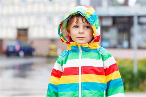 Happy Smiling Little Boy Walking In City Through Rain Stock Image ...