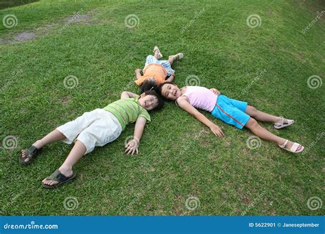 Kids lying on the grass stock image. Image of life, lawn - 5622901