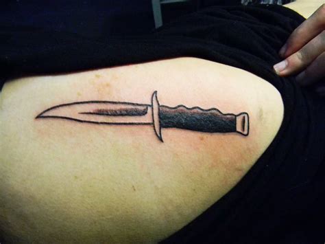 Back tattoo of a knife by Craigy Lee.