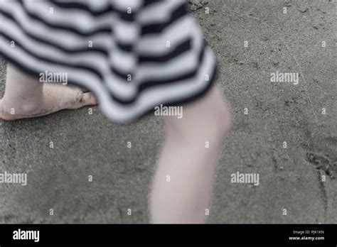 Girl truncated while running barefoot on the beach Stock Photo - Alamy