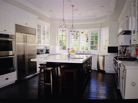 Kitchen.... Dark wood look floors. White cabinets and slate appliances. | White kitchen ...