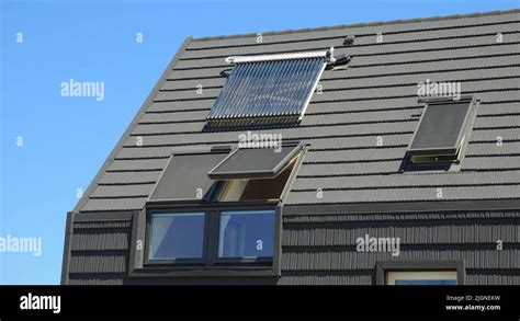 Modern house rooftop with attic panoramic windows. Attic skylight windows Stock Photo - Alamy