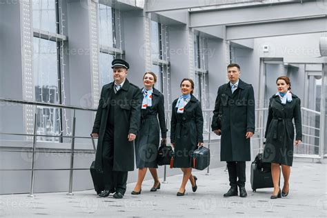 Aircraft crew in work uniform is together outdoors in the airport 15458322 Stock Photo at Vecteezy