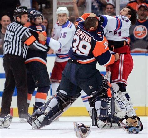 New York Islanders goalie Rick DiPietro (39) and New York Rangers goalie Al Montoya fight as ...