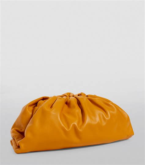 Bottega Veneta orange Leather The Pouch Clutch Bag | Harrods UK