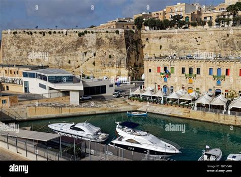 Cafes and Restaurants line the Valletta Waterfront beneath the ...