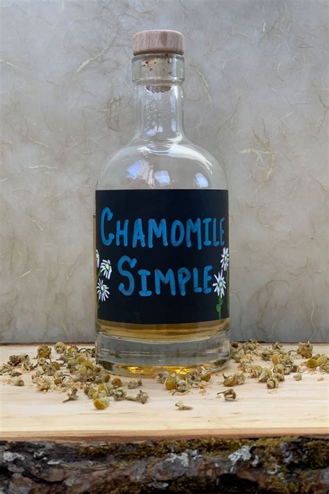 a bottle of chamomile sitting on top of a wooden table