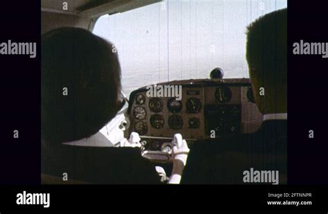 1970s: Lady flies plane. Lady turns plane in sky Stock Video Footage - Alamy