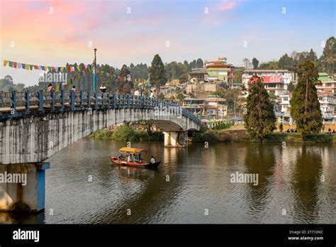 Mirik Lake with its cityscape and view of tourists boating at sunset. Mirik is a popular hill ...