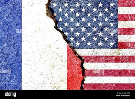 France vs USA national flags isolated on cracked dirty wall background ...