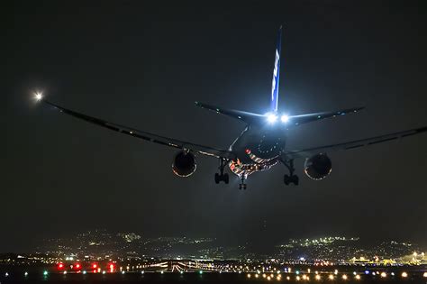 Nighttime Cityscape: HD Wallpaper of Aircraft in Flight