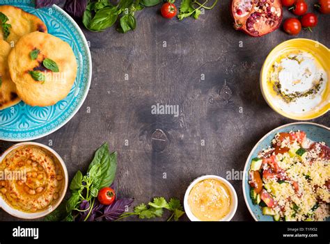 Table served with middle eastern vegetarian dishes. Hummus, tahini ...