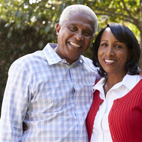 Senior black couple in their garden looking to camera - Lakeland Regional Health