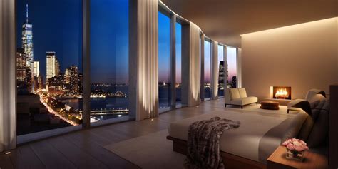 a living room filled with furniture and large windows overlooking the city lights at night time