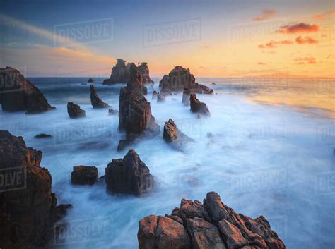 Rocky beach at sunset, Pegadung Beach, Lampung, Indonesia - Stock Photo ...