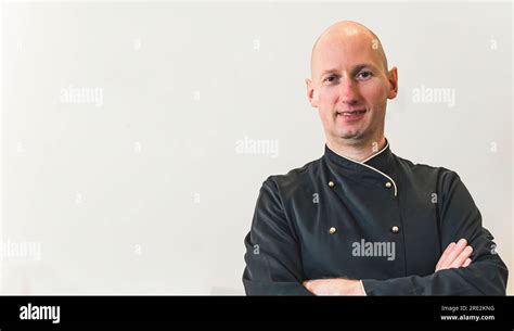 Male bald chef isolated on white background with copy space. Smiling ...