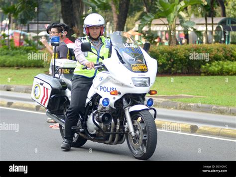 Indonesian police motor patrol Stock Photo - Alamy