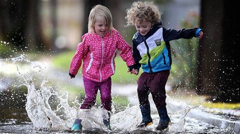 child in rain | India and Frank splashing on street puddles in ...