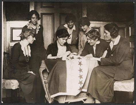 Alice Paul sews a star onto the NWP Ratification Flag, representing ...