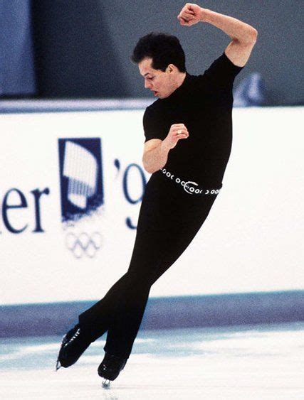 a male figure skating on an ice rink