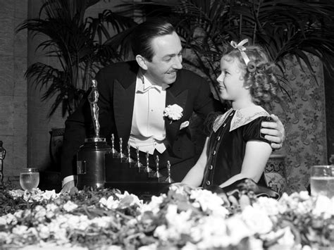 Shirley Temple presenting Walt Disney with a special Oscar at the 1939 ...