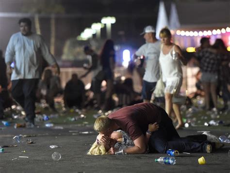 a man is laying on the ground with his head in his hands as people ...