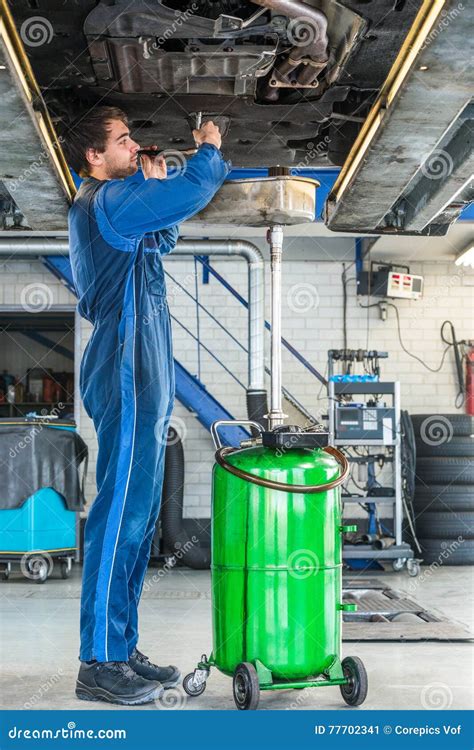 Mechanic Repairing Car on Hydraulic Lift in Automobile Shop Stock Image - Image of skill ...