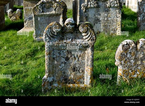 Old gravestones in St. Mary`s churchyard, Swinbrook, Oxfordshire, England, UK Stock Photo - Alamy