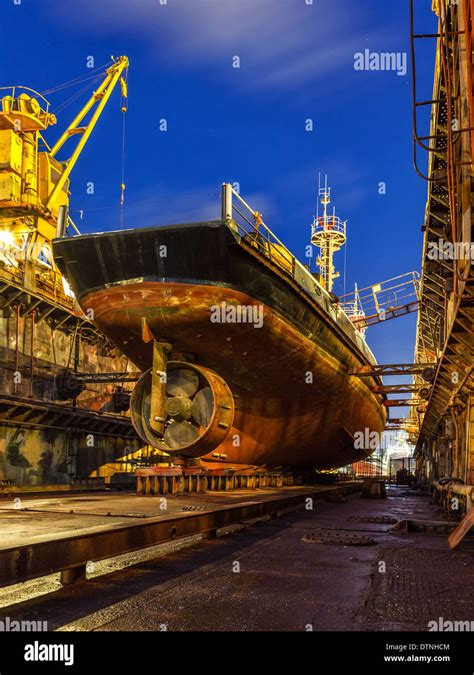 Ship repair in Dry Dock at night Stock Photo - Alamy