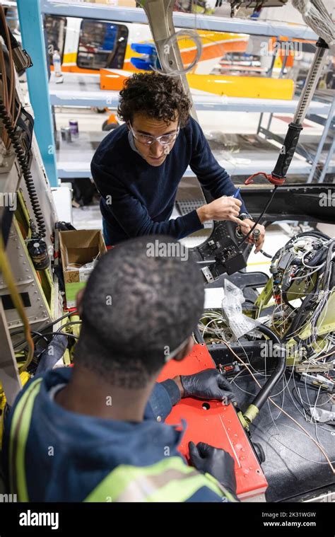 Technicians working on helicopter interior Stock Photo - Alamy