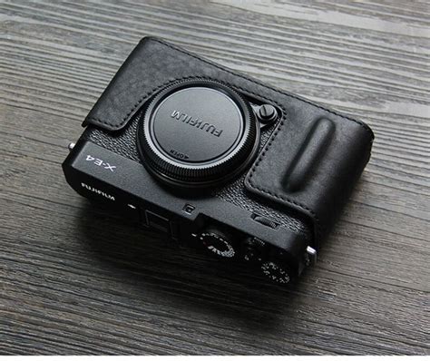 a black camera sitting on top of a wooden table