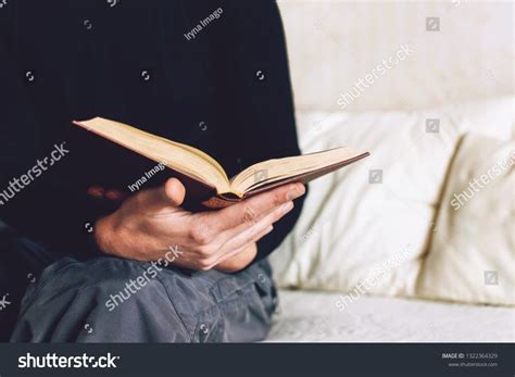 Man holding Open book in hands. Male hands hold a hardcover book ...