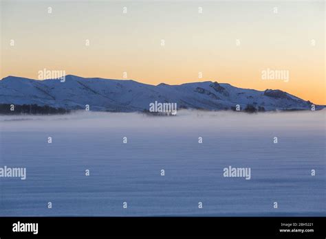 Snowy mountains at sunrise Stock Photo - Alamy