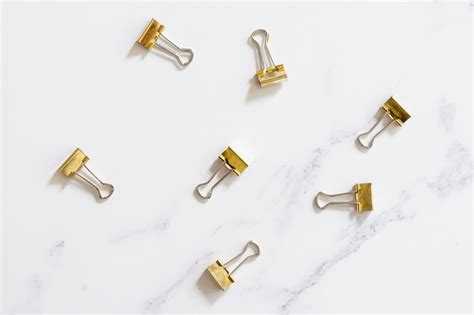 Free Photo | Gold paper clips on plain background