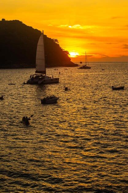 Premium Photo | A sunset with a sailboat and a sunset in the background