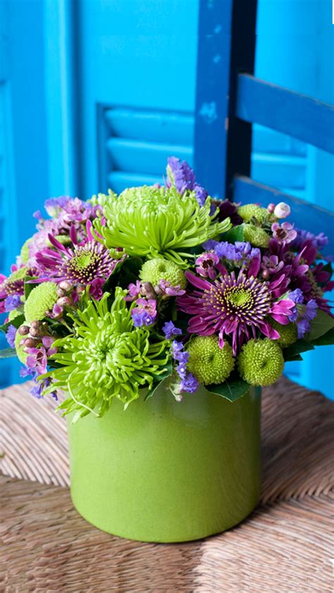 Beautiful seasonal flowers arrangement in green-lilac shades. Chrysanthemums, amaranth, wax ...