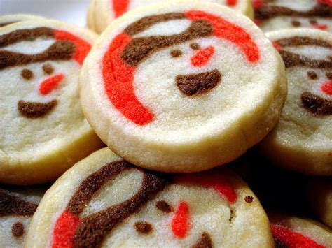 cookies decorated with red and brown icing on top of each other