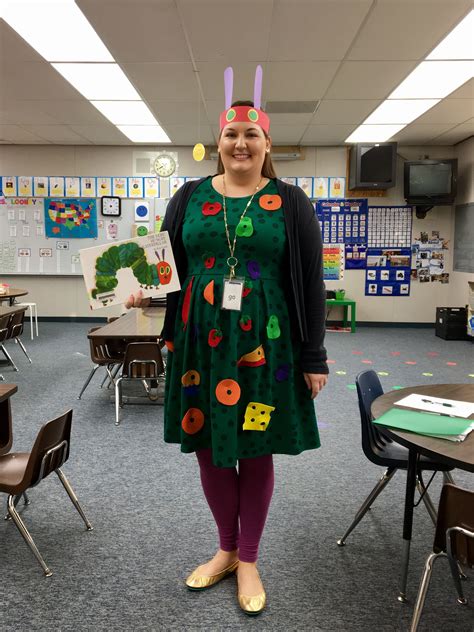 a woman standing in a classroom wearing a green dress with buttons on ...